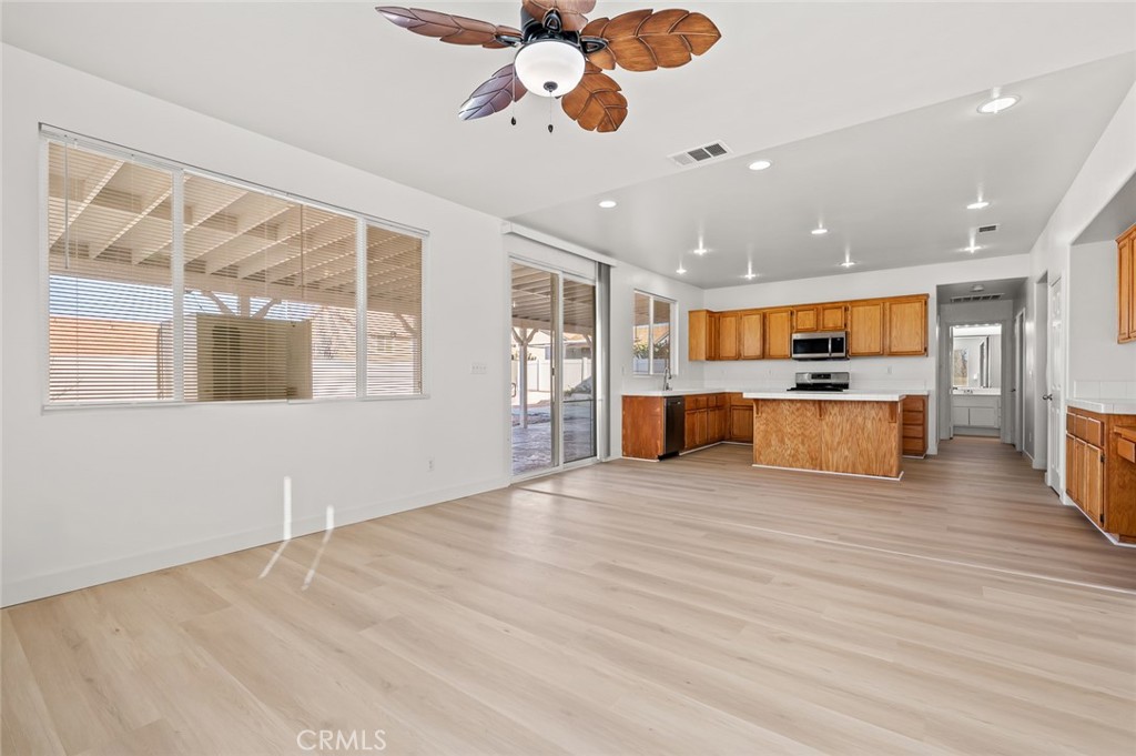 6323 Scalea Court Palmdale, CA 93552 - Photo 15 of 58 a view of an empty room with window and wooden floor