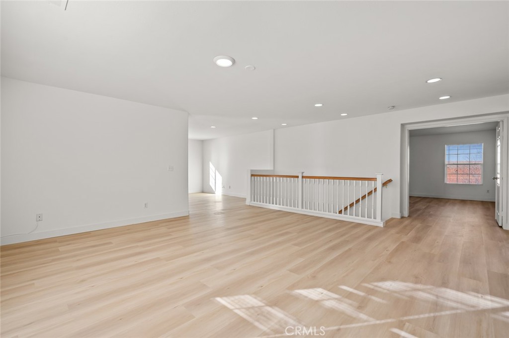 6323 Scalea Court Palmdale, CA 93552 - Photo 29 of 58 a view of an empty room with wooden floor and a window
