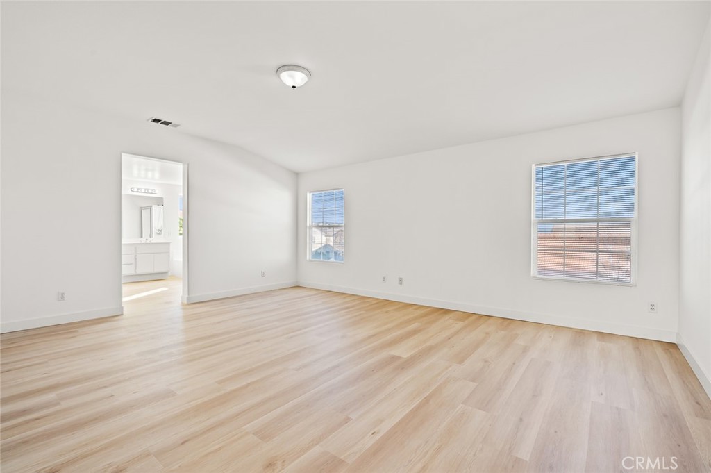6323 Scalea Court Palmdale, CA 93552 - Photo 42 of 58 an empty room with wooden floor and windows