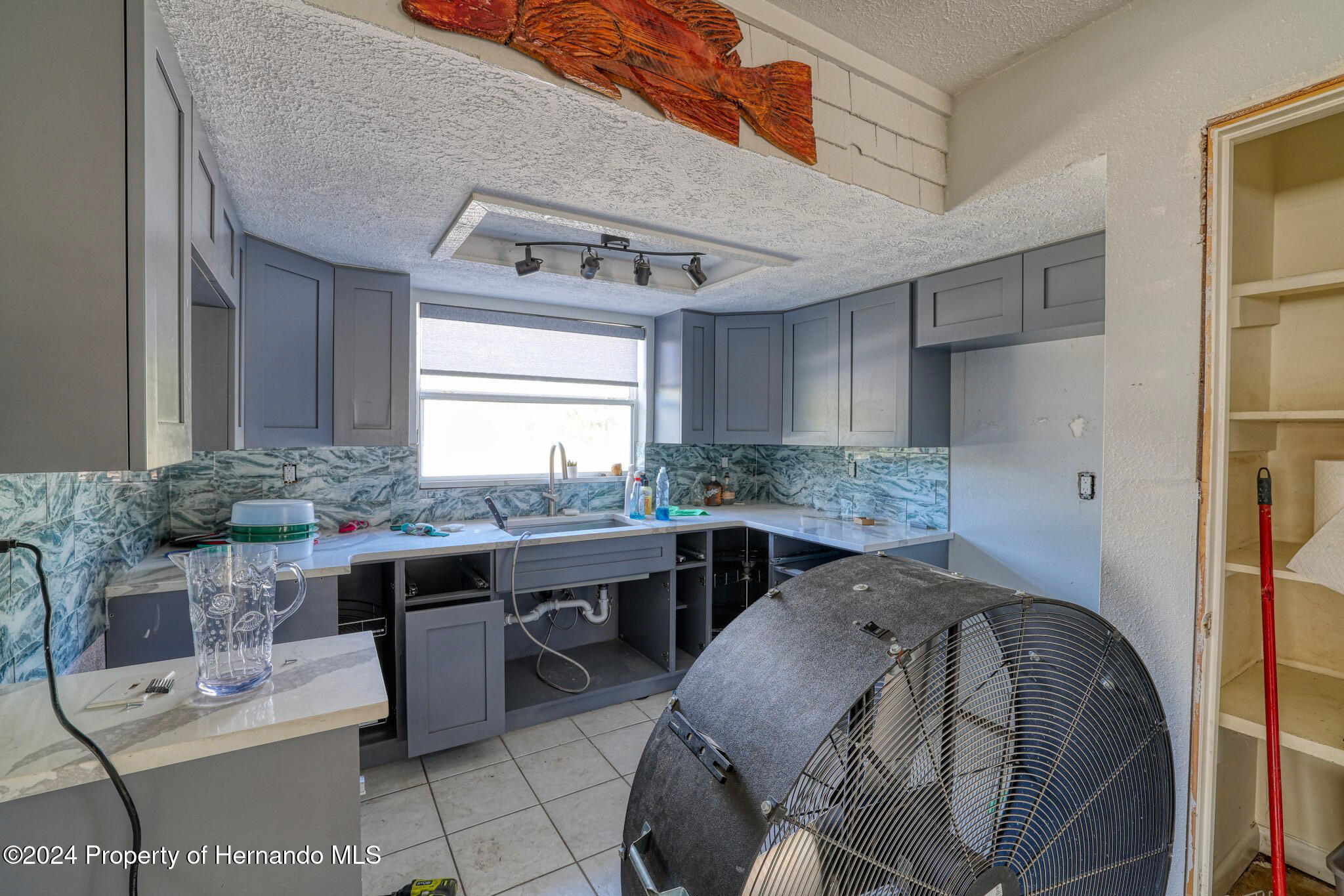 3186 Gulf Drive Aripeka, FL 34607 - Photo 12 of 19 a kitchen with a sink a stove a refrigerator and cabinets