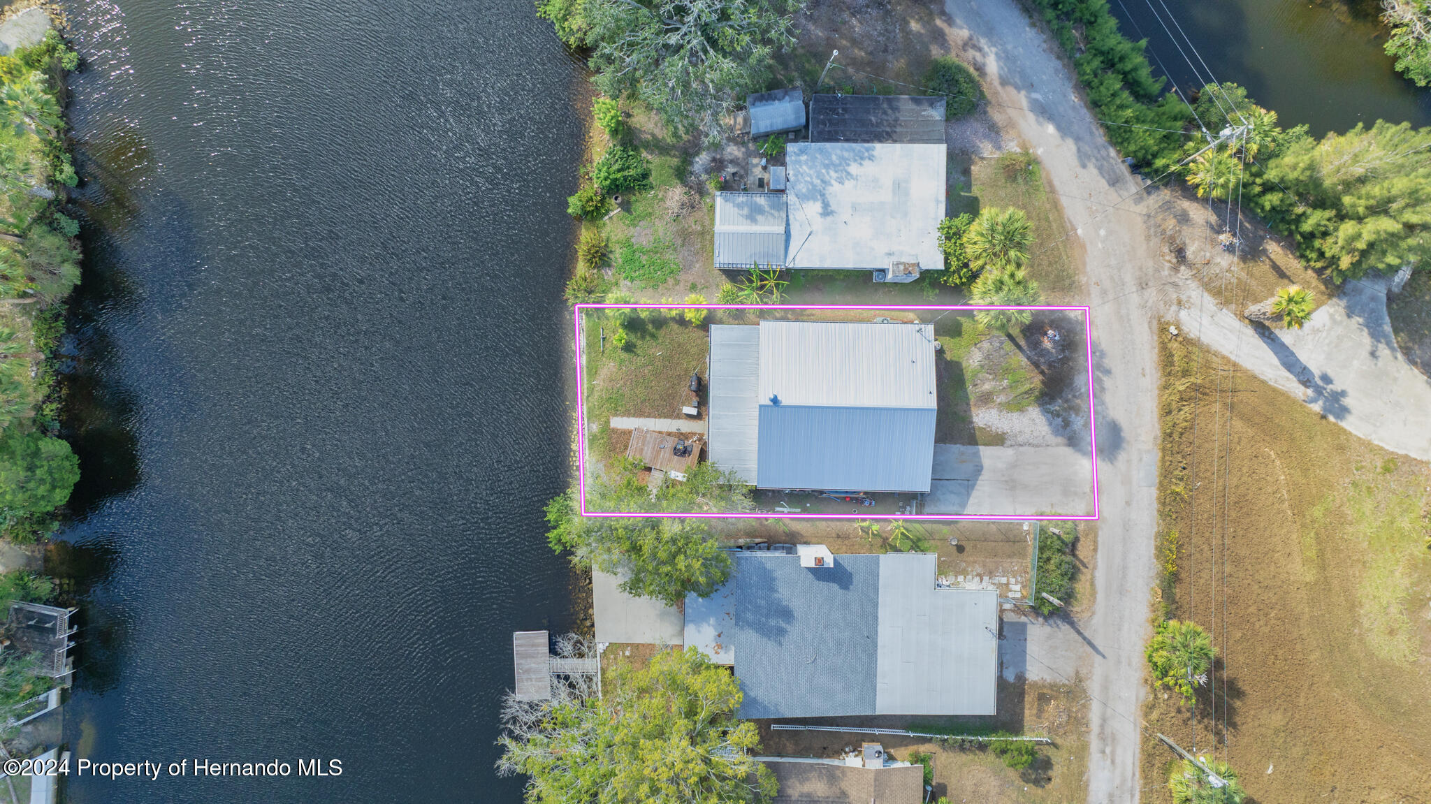 3186 Gulf Drive Aripeka, FL 34607 - Photo 2 of 19 an aerial view of a house with a yard