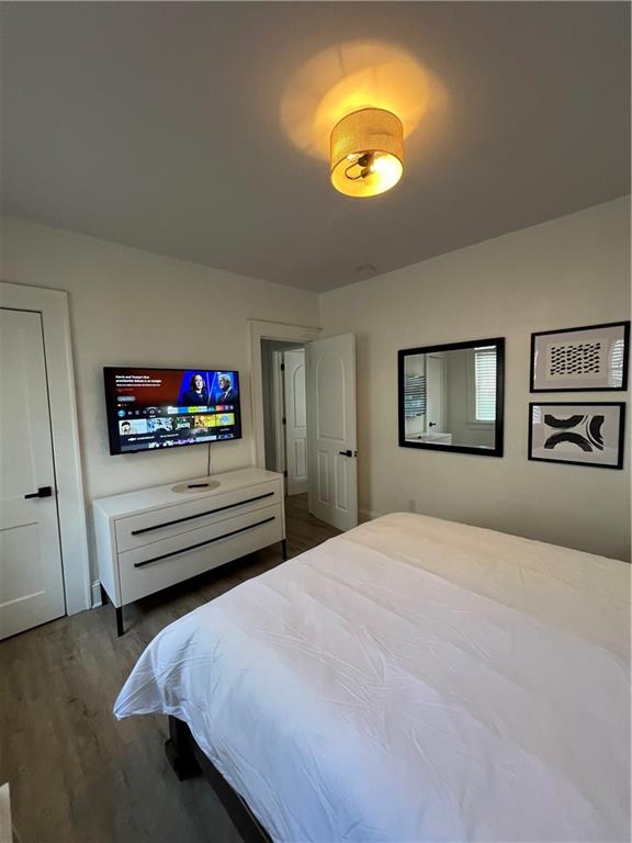 1474 Beecher Street Southwest Atlanta, GA 30310 - Photo 12 of 20 a bedroom with a bed and a chandelier