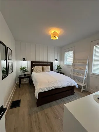 a bedroom with a bed and a tv