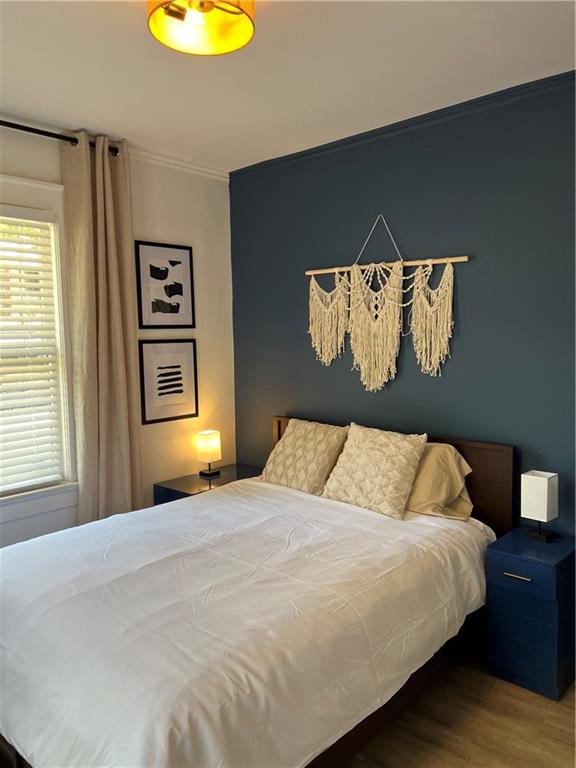 1474 Beecher Street Southwest Atlanta, GA 30310 - Photo 15 of 20 a bedroom with a bed and a painting on the wall