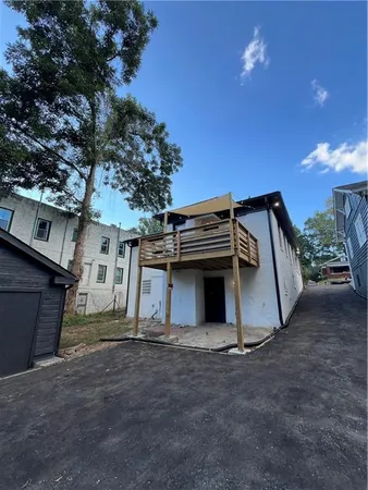 a view of a house with a space and a tree