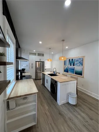 a kitchen with a sink and a stove top oven