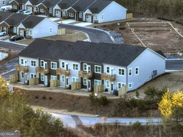 an aerial view of a house with a yard