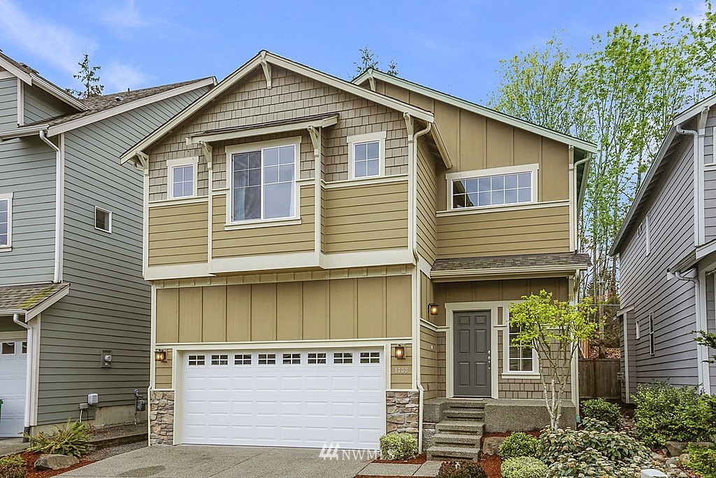 4733 Northeast 13th Place Renton, WA 98059 - Photo 1 of 20 a front view of a house with a yard and garage