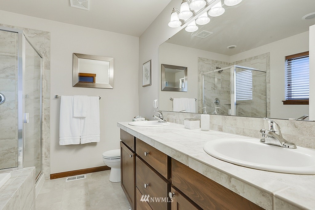 4733 Northeast 13th Place Renton, WA 98059 - Photo 13 of 20 a bathroom with a sink a mirror and a shower