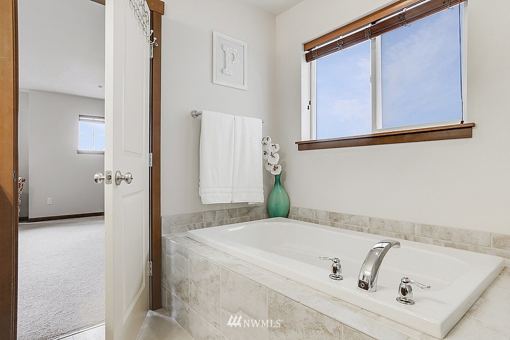 4733 Northeast 13th Place Renton, WA 98059 - Photo 14 of 20 a bathroom with a tub sink and mirror