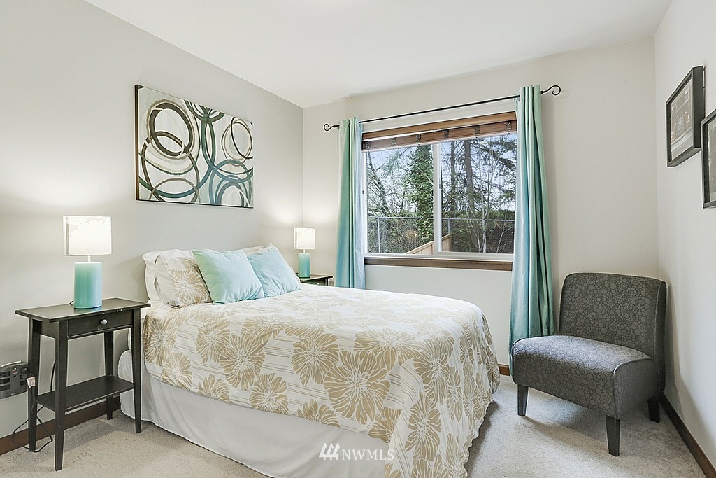 4733 Northeast 13th Place Renton, WA 98059 - Photo 16 of 20 a bedroom with a bed and a chair with window