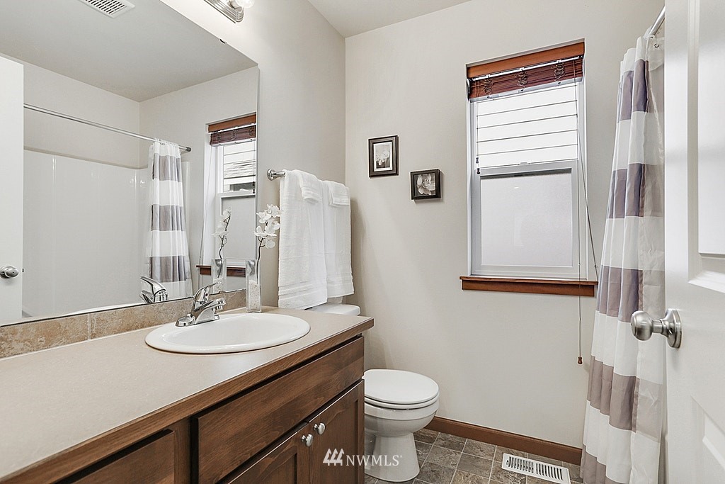 4733 Northeast 13th Place Renton, WA 98059 - Photo 19 of 20 a bathroom with a sink toilet and shower