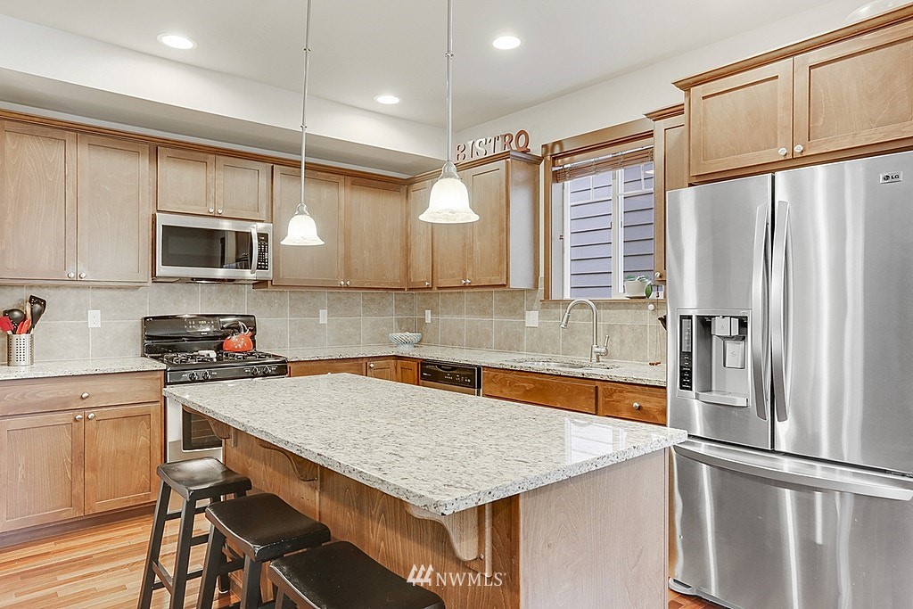 4733 Northeast 13th Place Renton, WA 98059 - Photo 3 of 20 a kitchen with a appliances a sink and cabinets