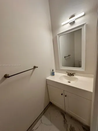 a bathroom with a double vanity sink and mirror