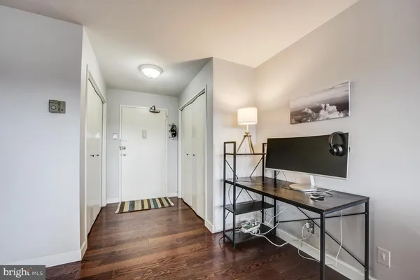 a view of a workspace with furniture and wooden floor