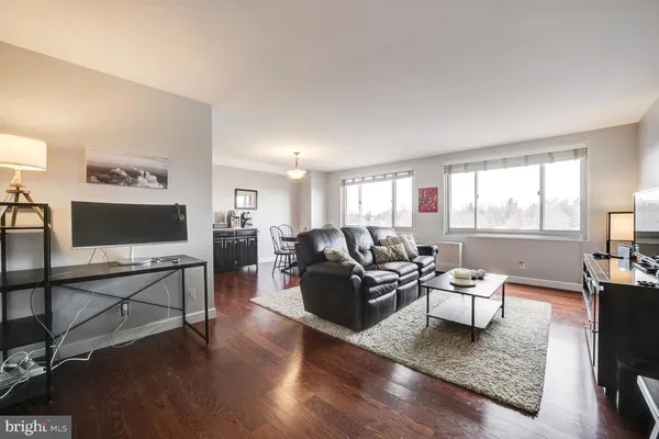 a living room with furniture a rug and a flat screen tv
