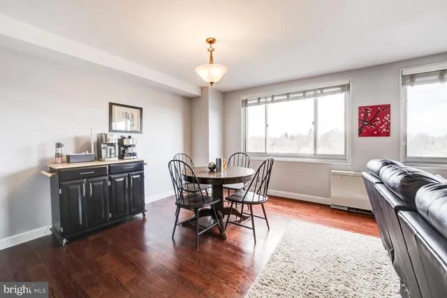 a view of a dining room with furniture window and wooden floor