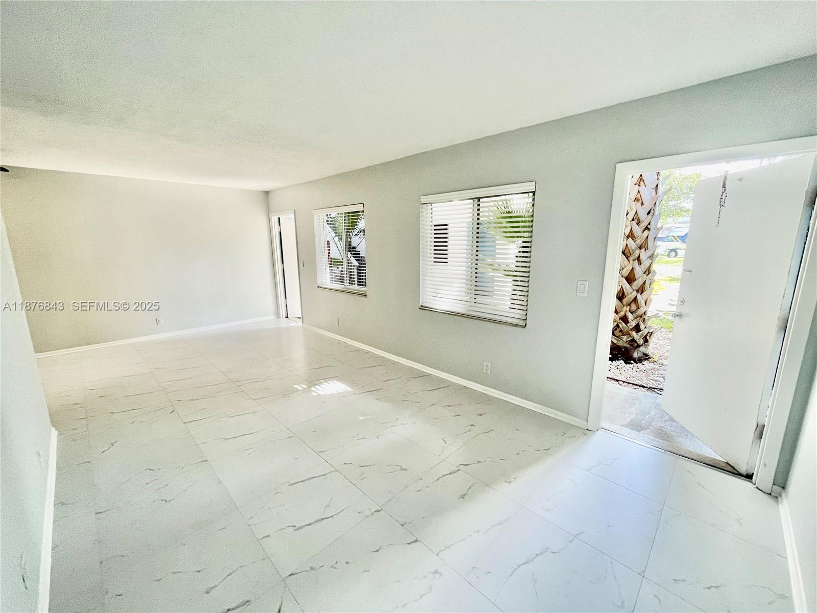 2616 Northeast 14th Avenue, Unit 2 Wilton Manors, FL 33334 - Photo 1 of 16 an empty room with windows