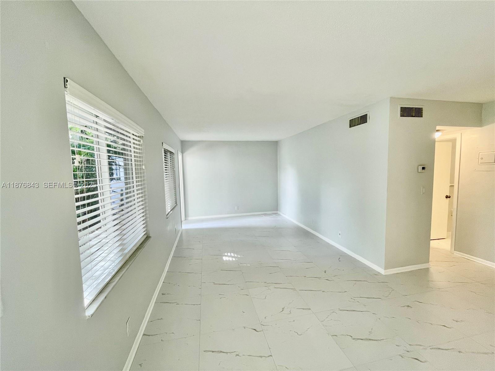 2616 Northeast 14th Avenue, Unit 2 Wilton Manors, FL 33334 - Photo 14 of 16 a view of an empty room with a window