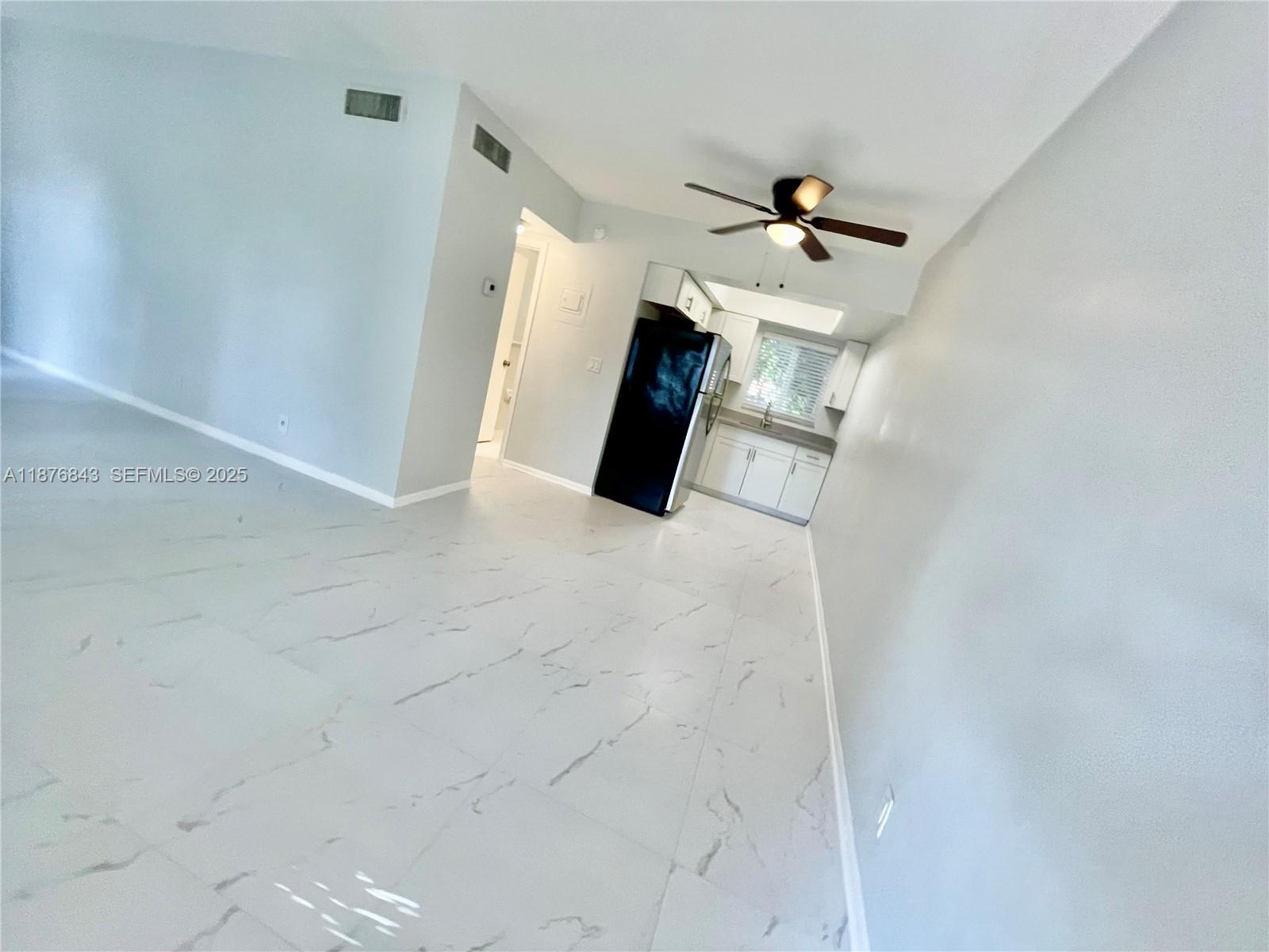 2616 Northeast 14th Avenue, Unit 2 Wilton Manors, FL 33334 - Photo 16 of 16 en empty room with wooden floor and ceiling fan