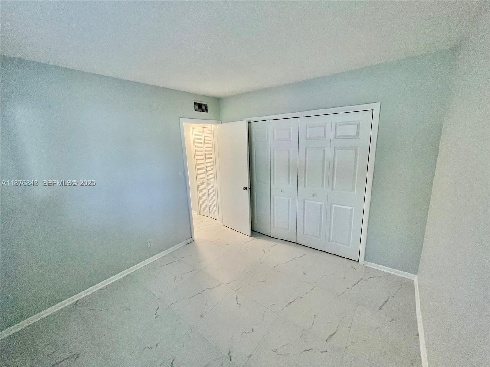 2616 Northeast 14th Avenue, Unit 2 Wilton Manors, FL 33334 - Photo 10 of 16 an empty room with an entryway