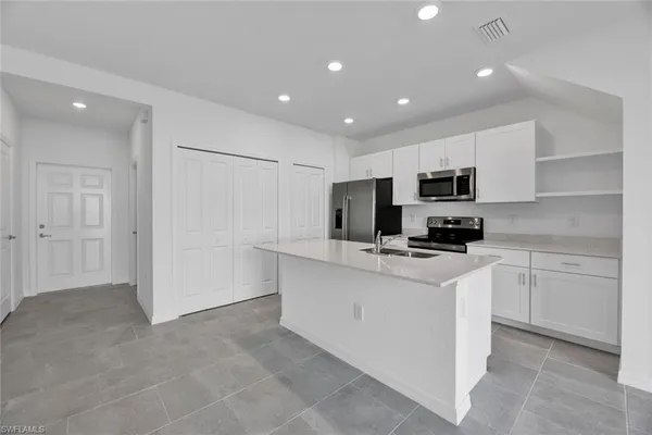 a kitchen with cabinets a sink and appliances