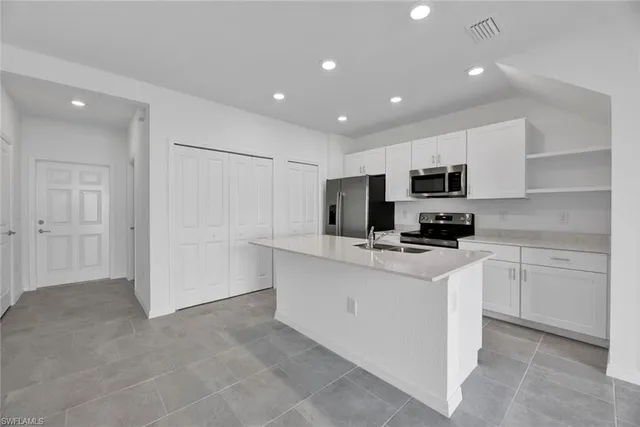 a kitchen with cabinets a sink and appliances
