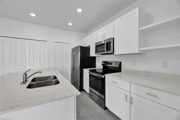 a kitchen that has a sink and a stove
