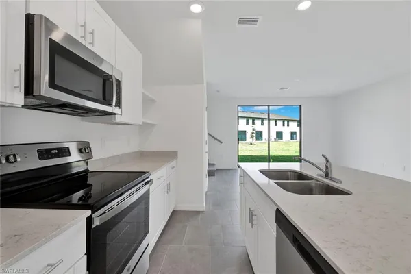 a kitchen that has a sink and a stove
