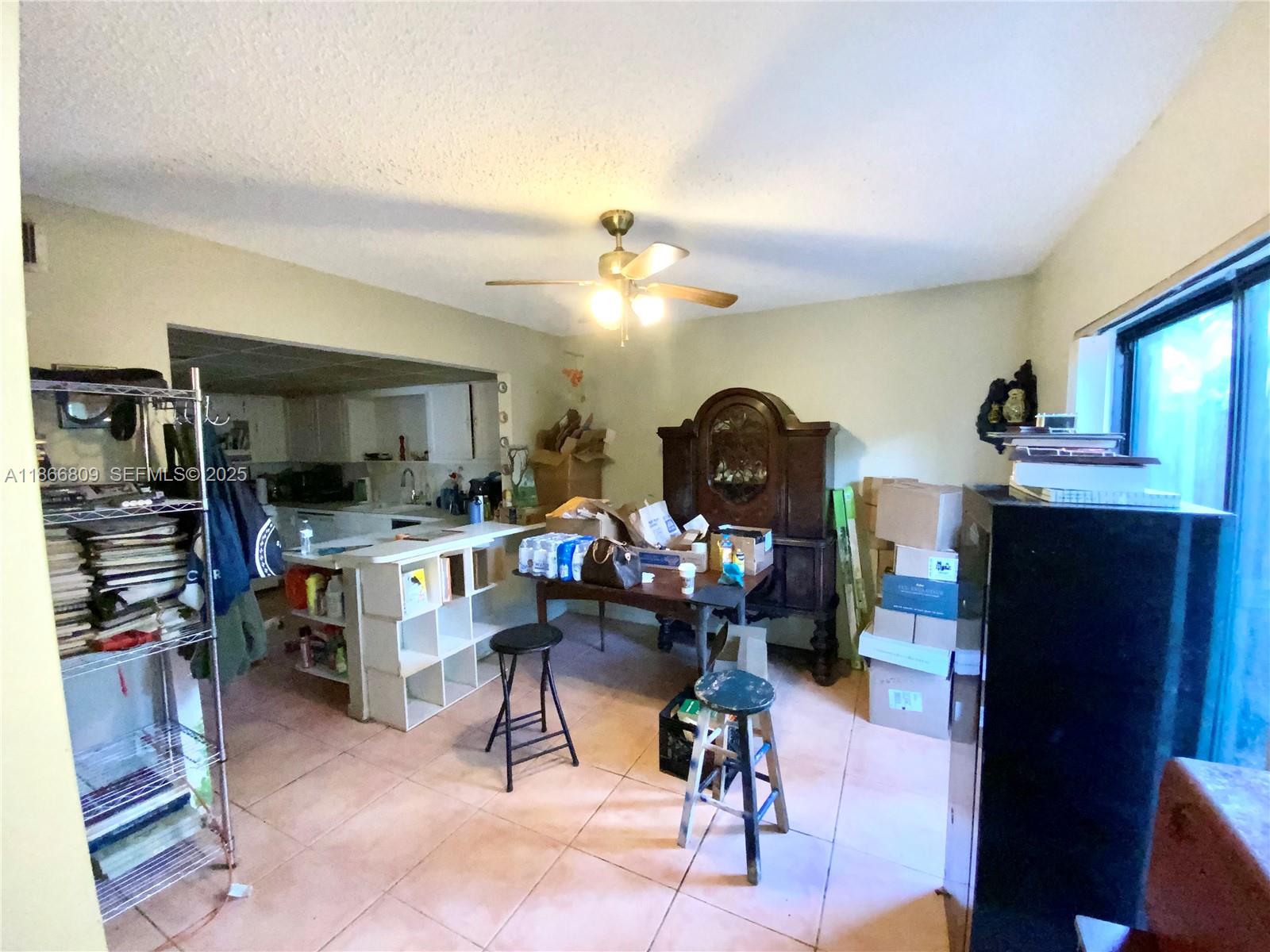 7024 Southwest 114th Place, Unit A52 Miami, FL 33173 - Photo 11 of 41 a living room filled with furniture and a flat screen tv