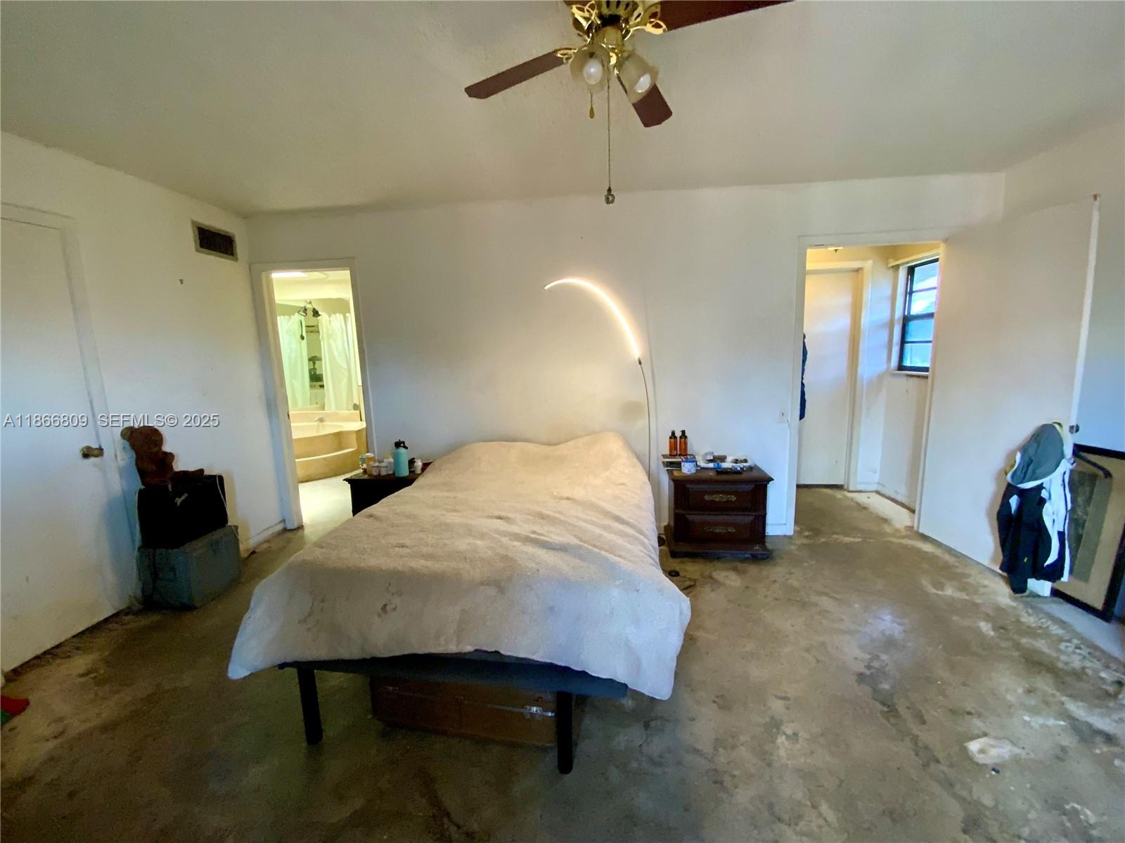 7024 Southwest 114th Place, Unit A52 Miami, FL 33173 - Photo 15 of 41 a bed room with a bed and a chandelier