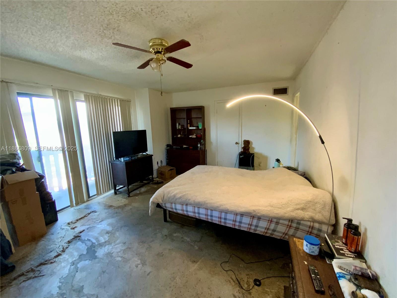 7024 Southwest 114th Place, Unit A52 Miami, FL 33173 - Photo 16 of 41 a bedroom with a bed and a flat tv screen on dresser