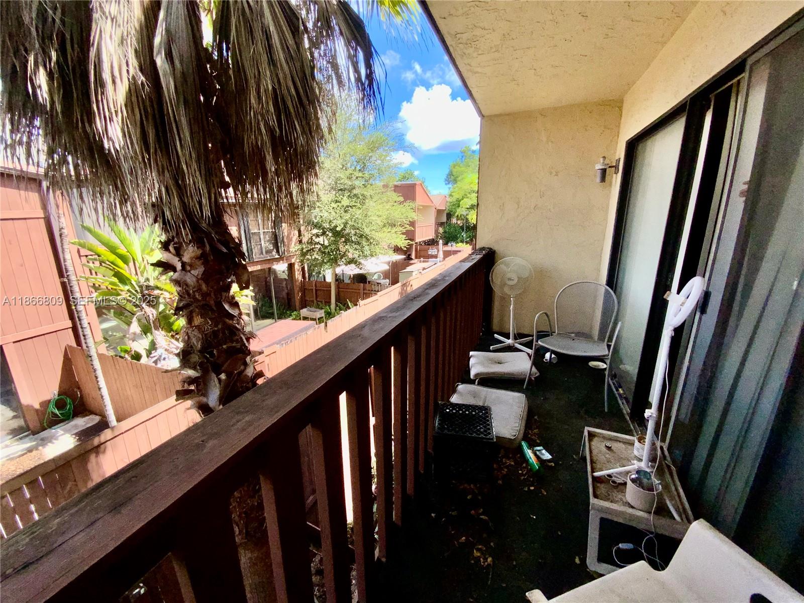 7024 Southwest 114th Place, Unit A52 Miami, FL 33173 - Photo 20 of 41 a view of balcony with wooden floor