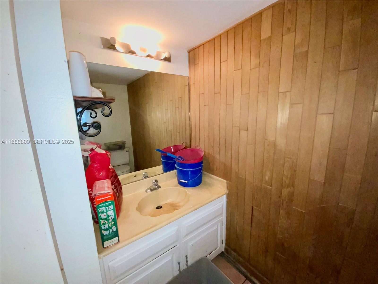 7024 Southwest 114th Place, Unit A52 Miami, FL 33173 - Photo 23 of 41 a bathroom with a sink a toilet and shower curtain