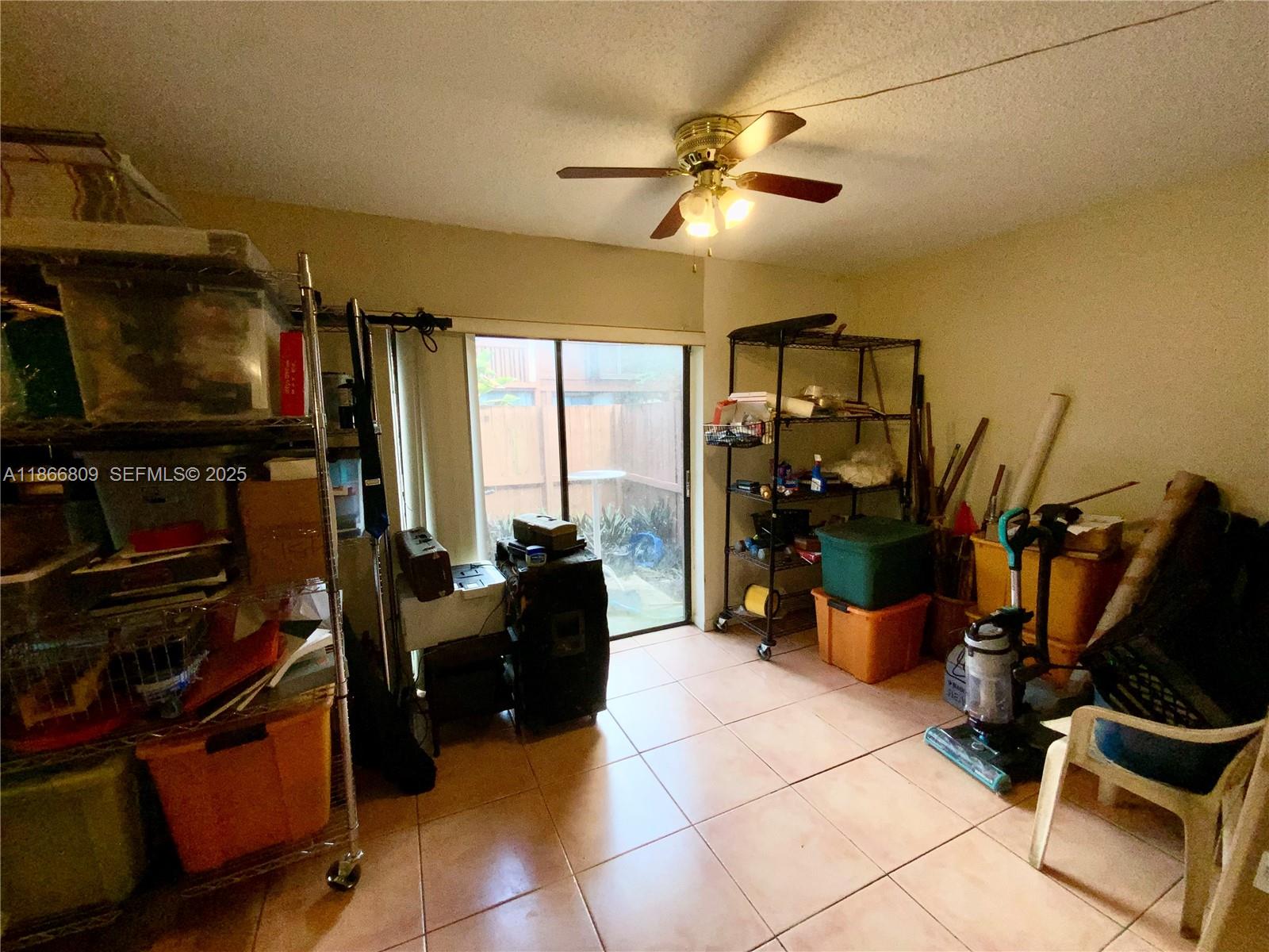 7024 Southwest 114th Place, Unit A52 Miami, FL 33173 - Photo 25 of 41 a living room with furniture a flat screen tv and gym equipment