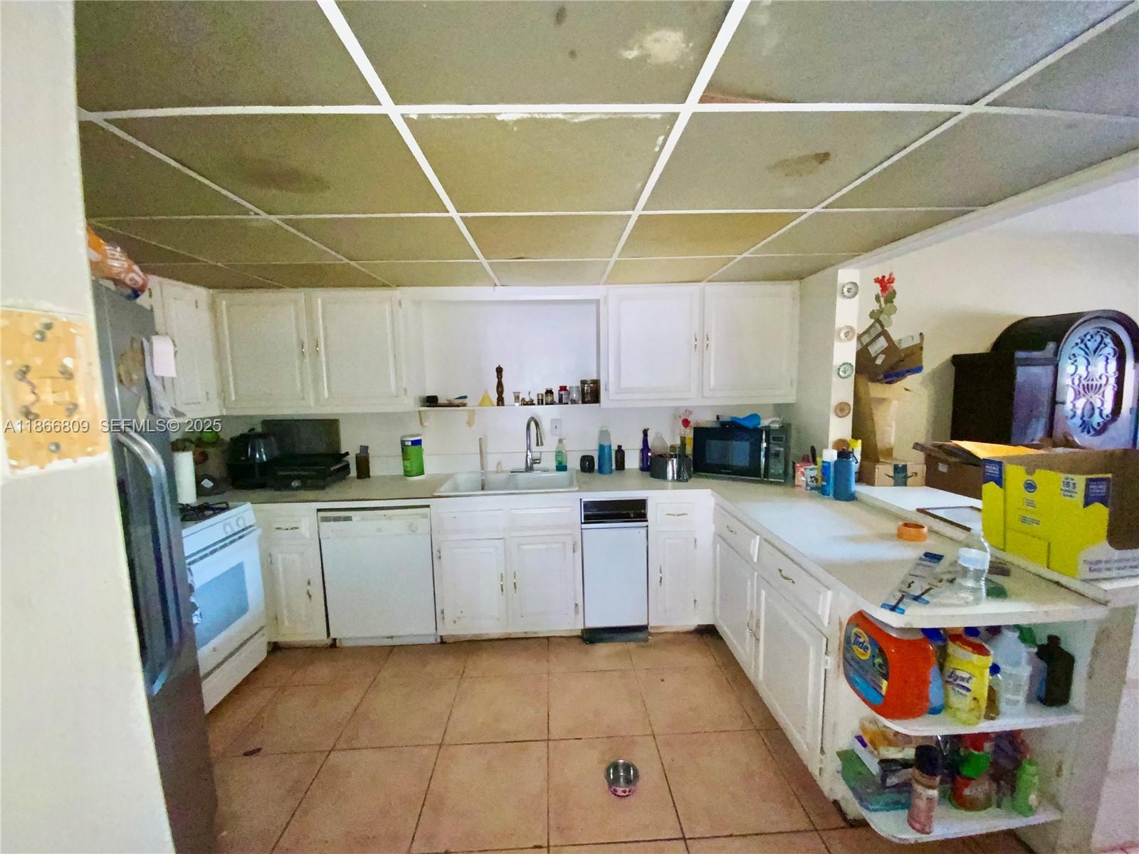 7024 Southwest 114th Place, Unit A52 Miami, FL 33173 - Photo 3 of 41 a kitchen with stainless steel appliances granite countertop a sink and cabinets
