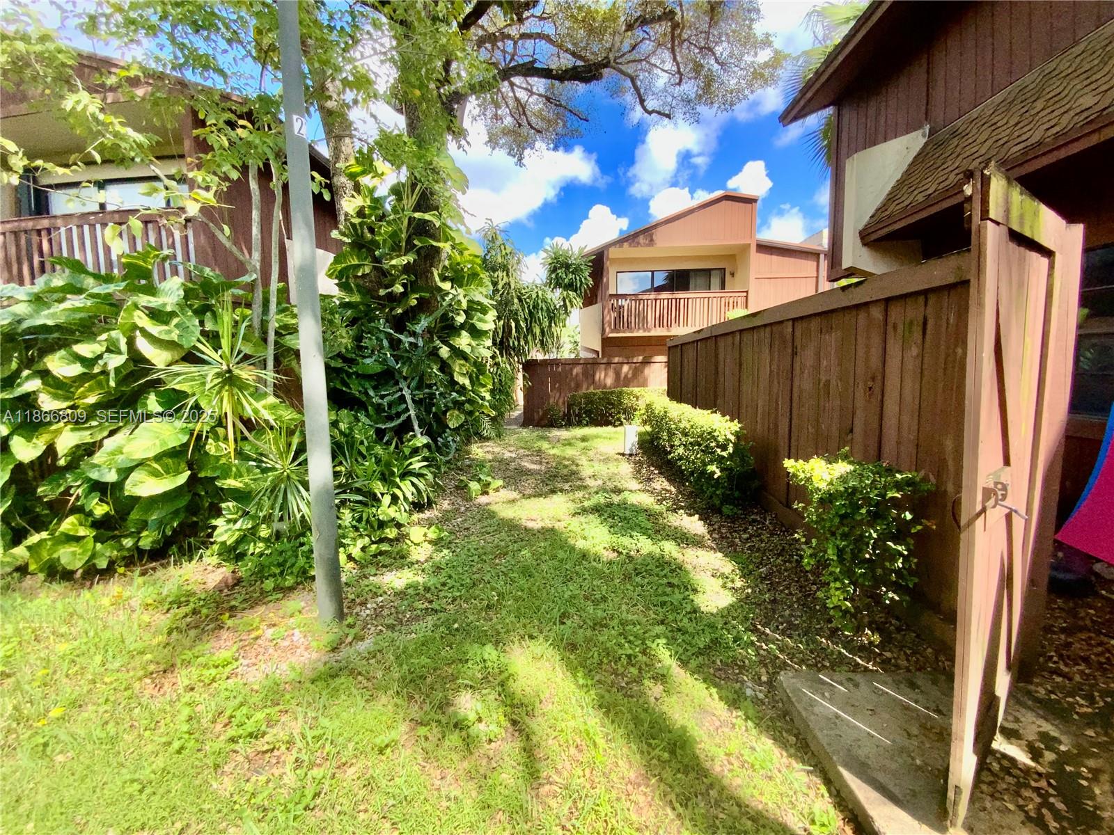 7024 Southwest 114th Place, Unit A52 Miami, FL 33173 - Photo 31 of 41 a backyard of a house with lots of green space