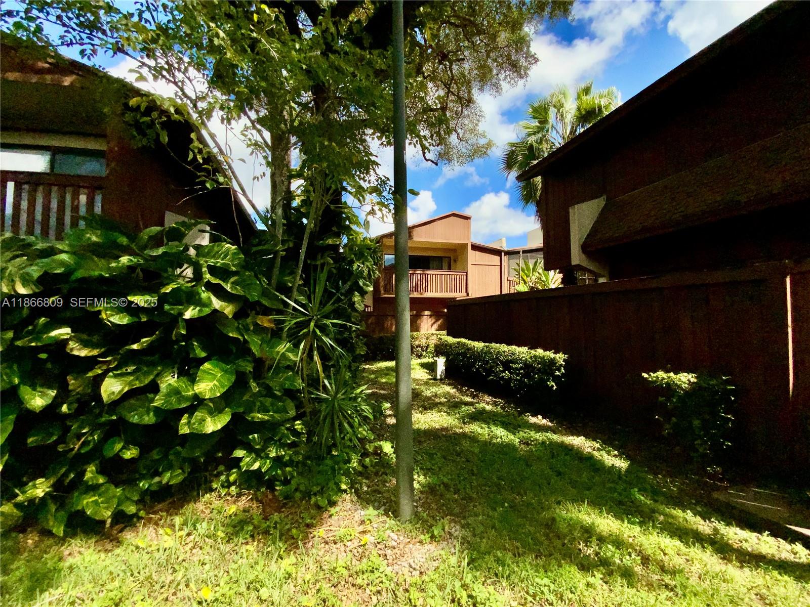 7024 Southwest 114th Place, Unit A52 Miami, FL 33173 - Photo 32 of 41 a backyard of a house with lots of green space