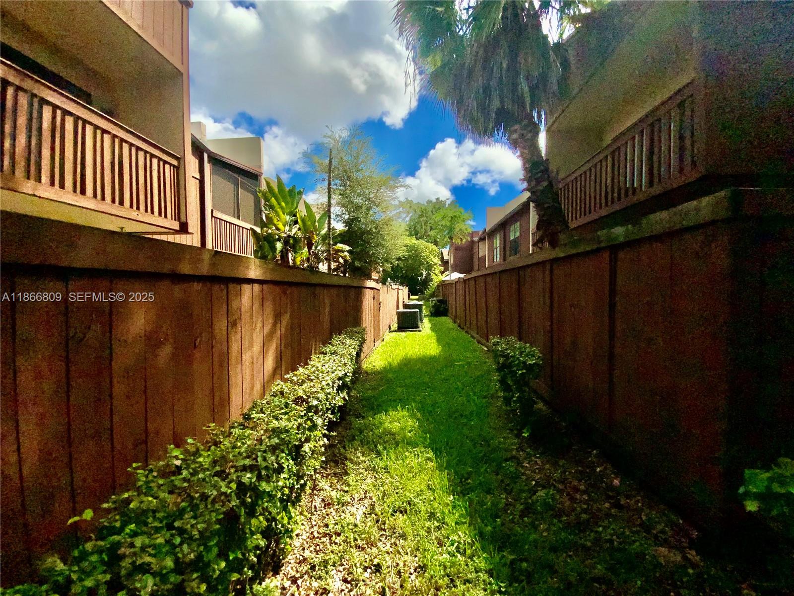 7024 Southwest 114th Place, Unit A52 Miami, FL 33173 - Photo 34 of 41 a view of a house with a yard and flower plants