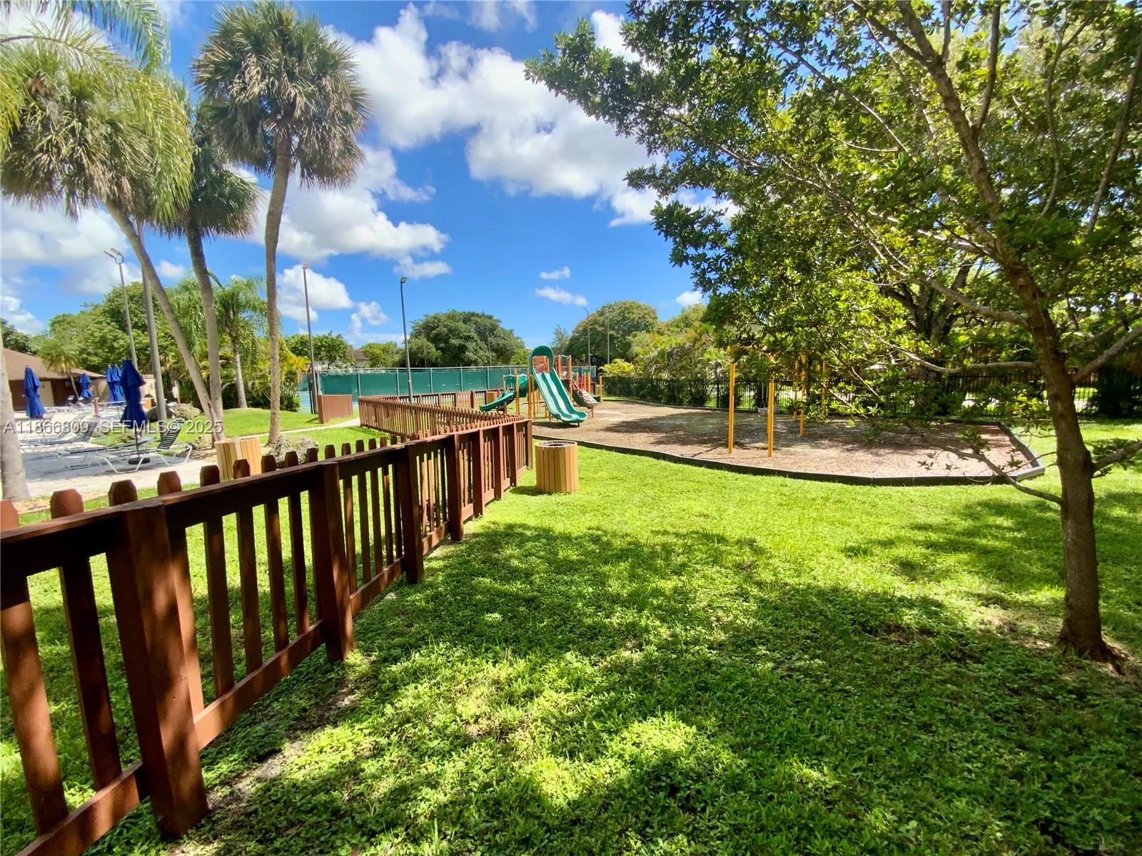 7024 Southwest 114th Place, Unit A52 Miami, FL 33173 - Photo 37 of 41 a view of a garden from a lake