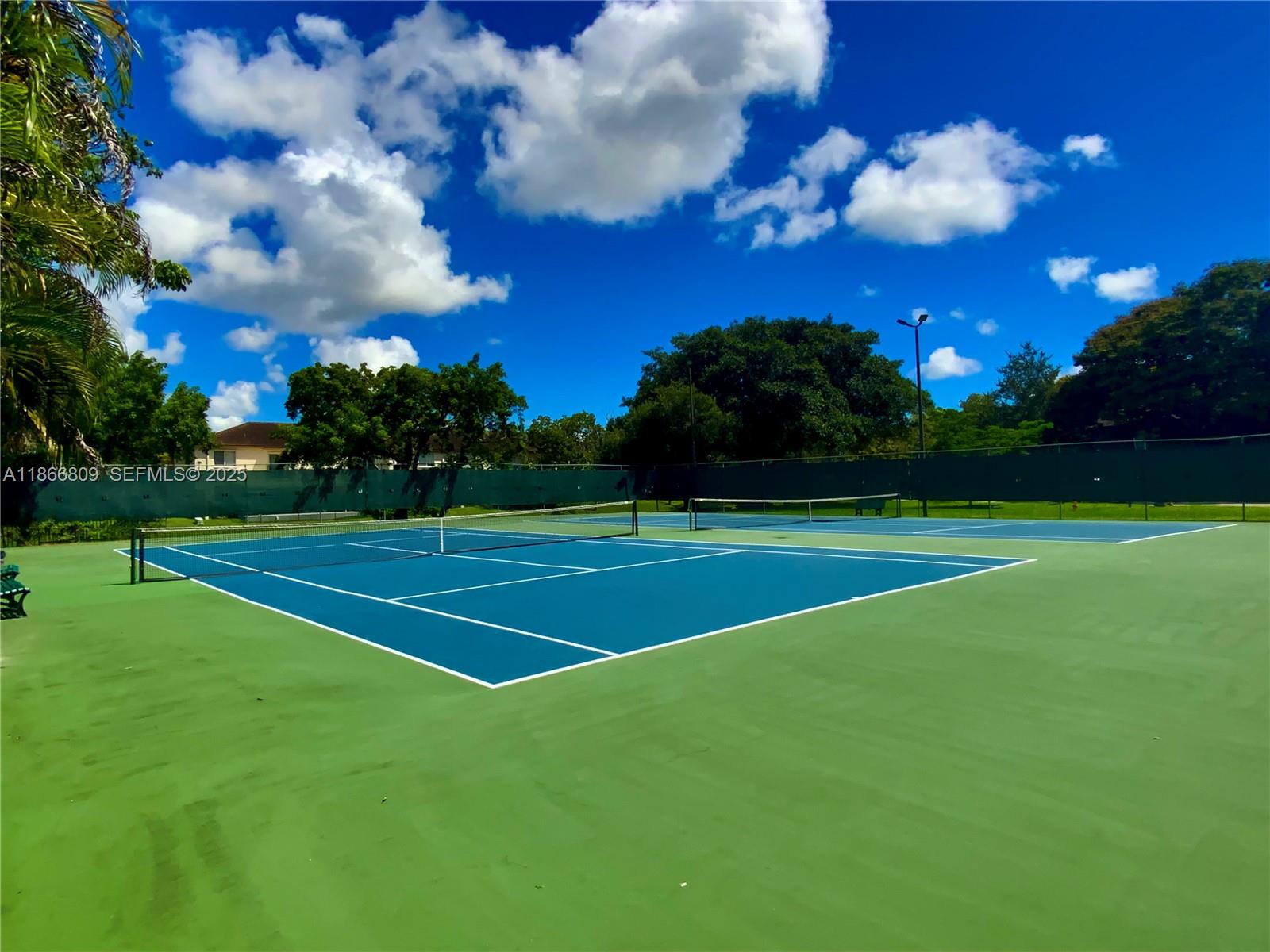 7024 Southwest 114th Place, Unit A52 Miami, FL 33173 - Photo 40 of 41 a view of a golf course with a lake