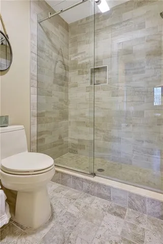 a bathroom with a toilet and a shower