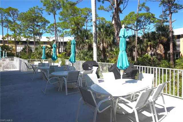 a view of a patio with a table and chairs