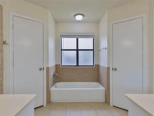 a bathroom with a bathtub and a shower