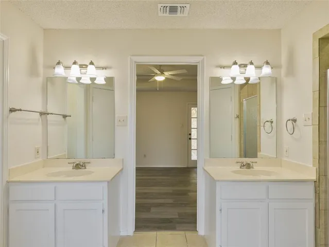 a bathroom with a double vanity sink and a mirror