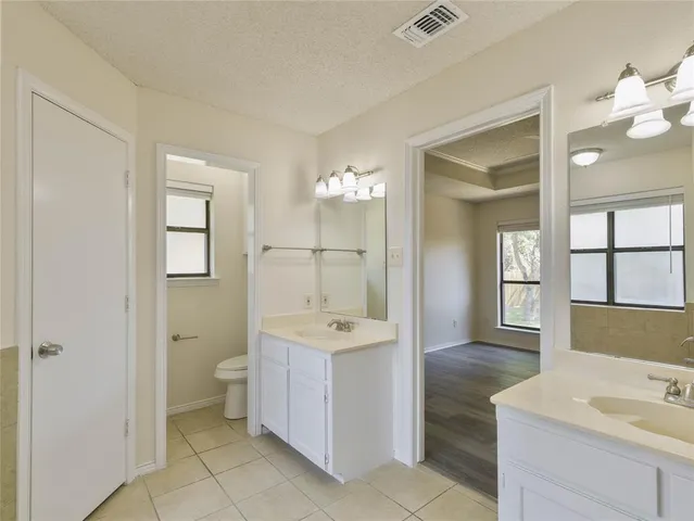 a spacious bathroom with a sink double vanity and a mirror