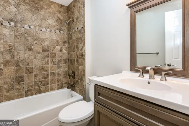 a bathroom with a sink a toilet and bathtub