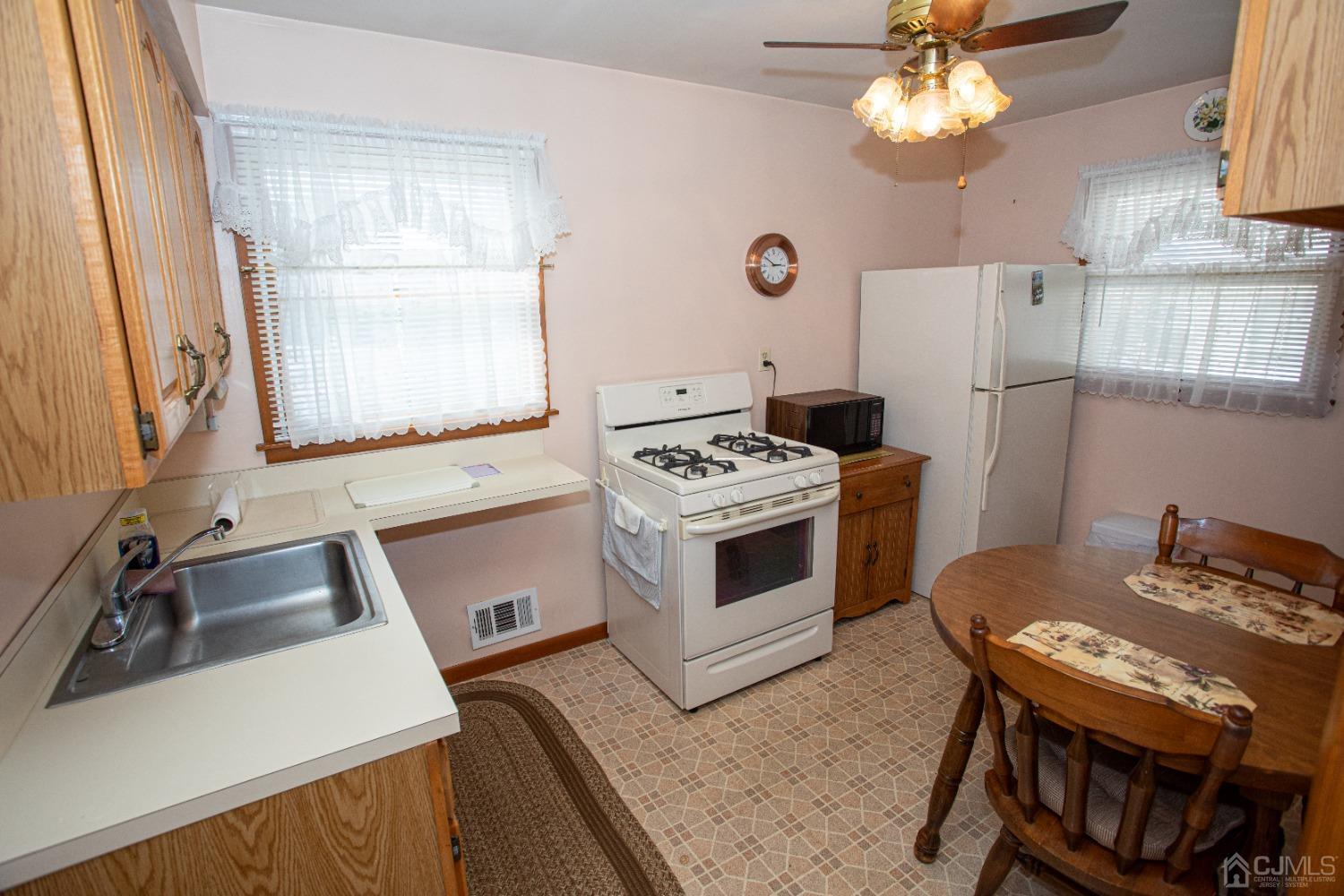9 Becker Drive Sayreville, NJ 08859 - Photo 14 of 39 a kitchen with a stove a sink and a refrigerator