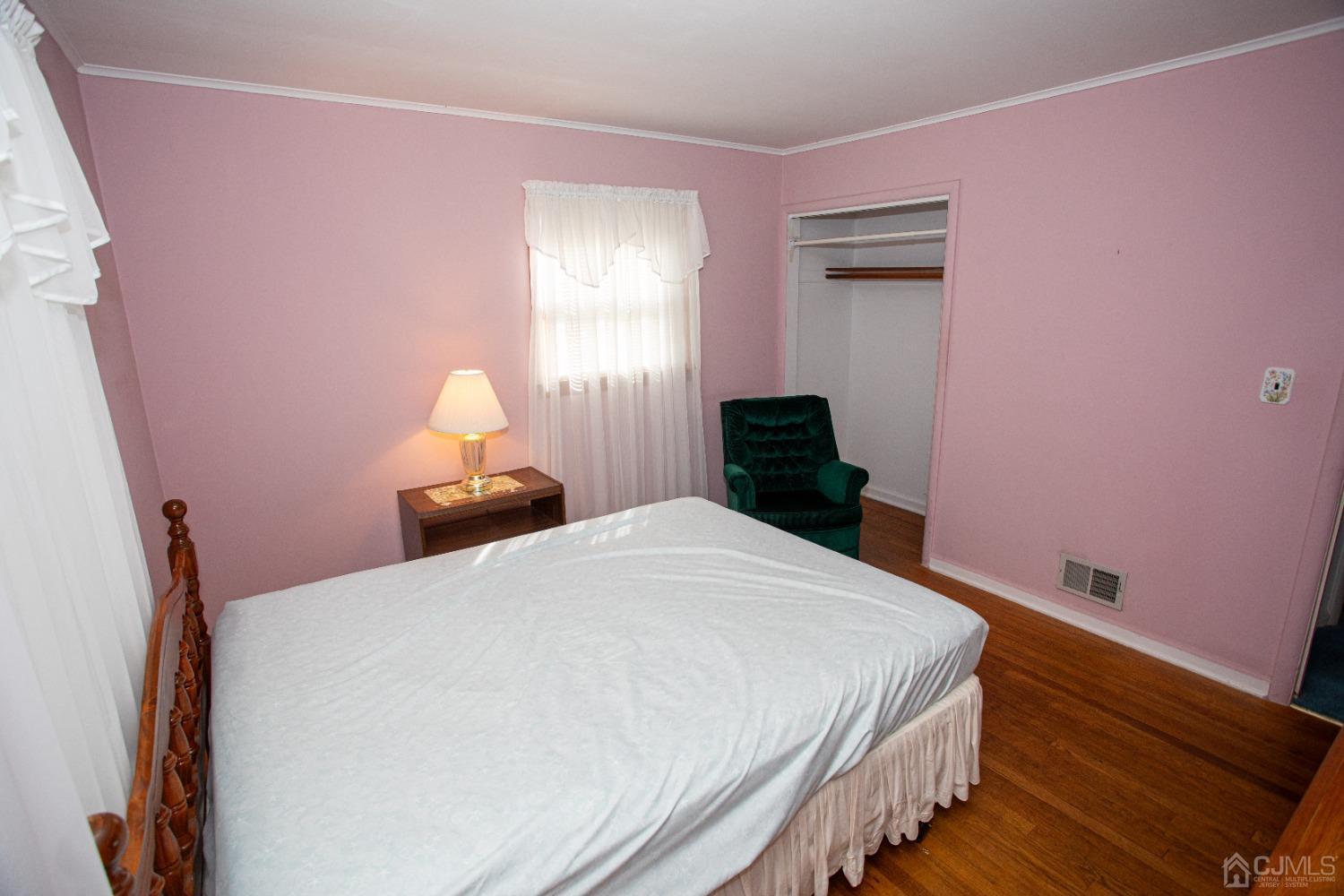 9 Becker Drive Sayreville, NJ 08859 - Photo 16 of 39 a bedroom with a bed and a lamp on dresser