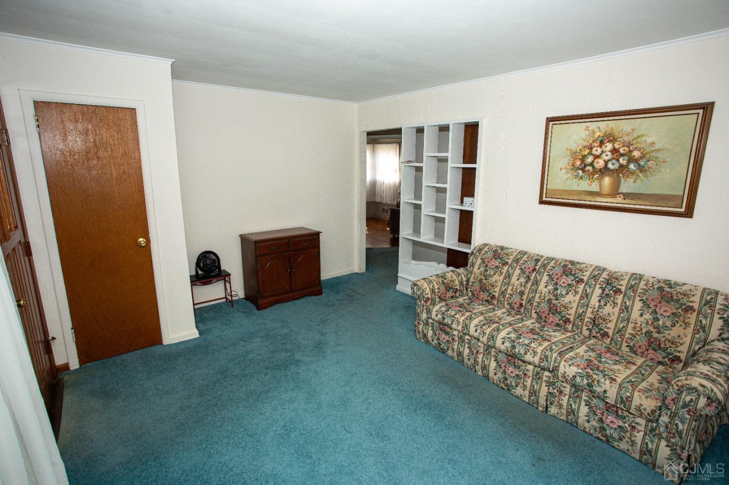 9 Becker Drive Sayreville, NJ 08859 - Photo 2 of 39 a living room with furniture and a gate